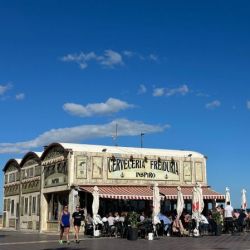 Slide 7: Cervezas on the boardwalk under a perfect blue sky